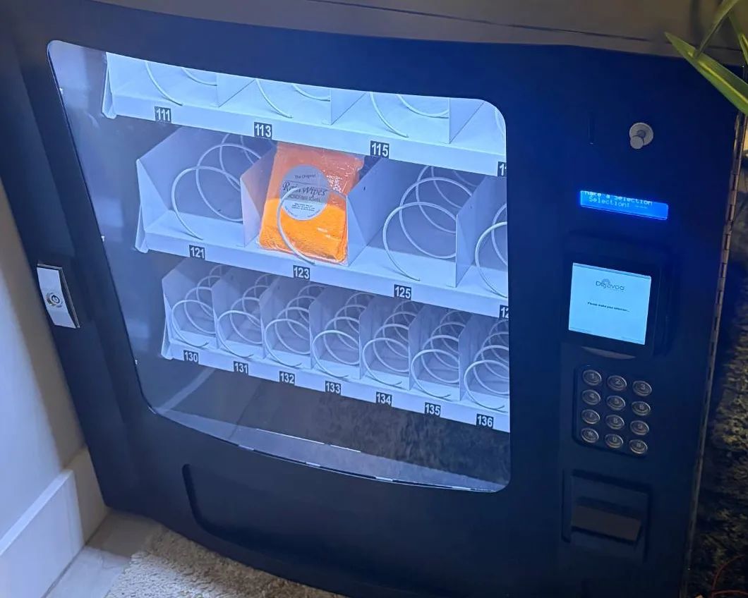 A Rain Pay reader installed on a Seaga SM1600 countertop vending machine, beside the selection keypad and the coin and bill slots